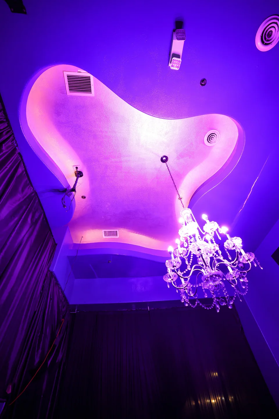 Crystal chandelier beneath Star’s sculpted pink ceiling