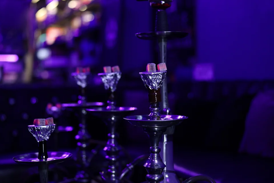 A hookah bowl framed by soft lounge lights