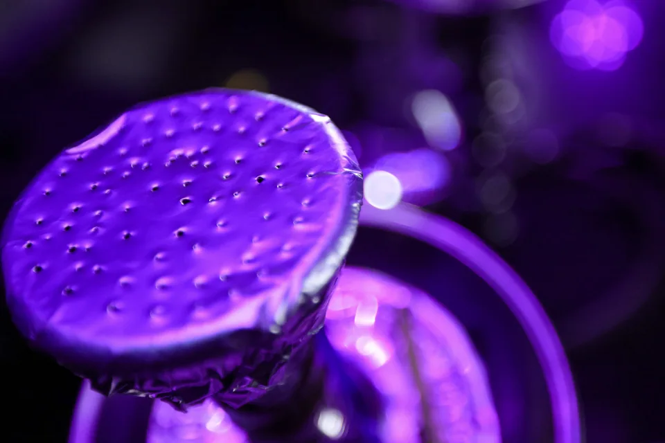 A close-up of a foil-covered hookah bowl