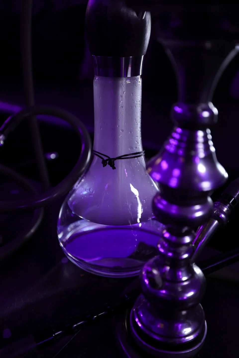 A close-up of a glass hookah base