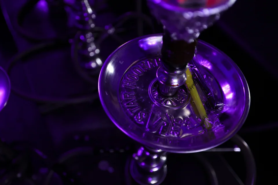 A diagonal view of a hookah stem and glass base