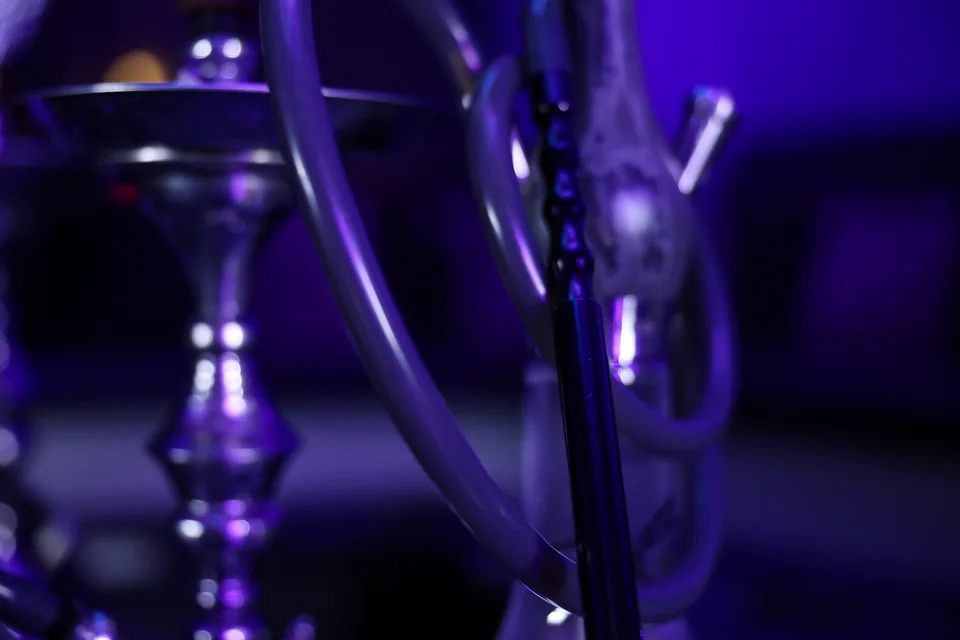 A close-up of a hookah connection and hose