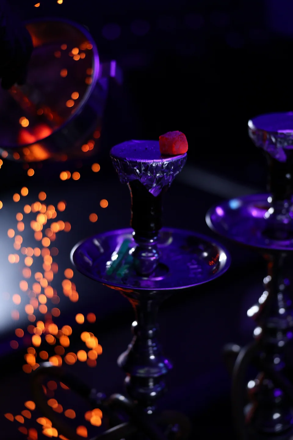 A close-up of sparks beside a hookah bowl