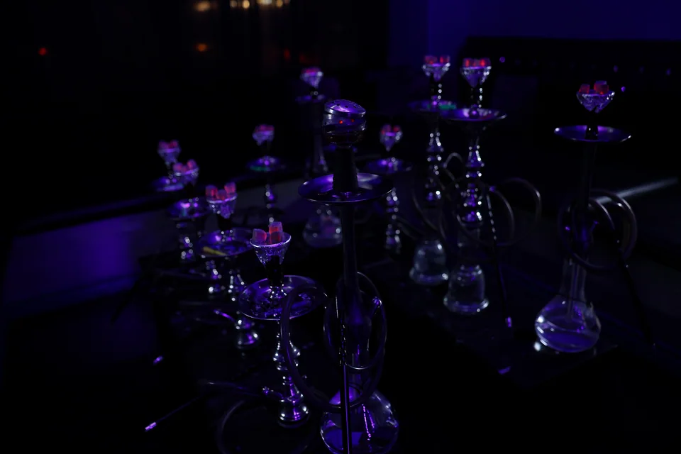 A full display of hookahs under lounge lighting