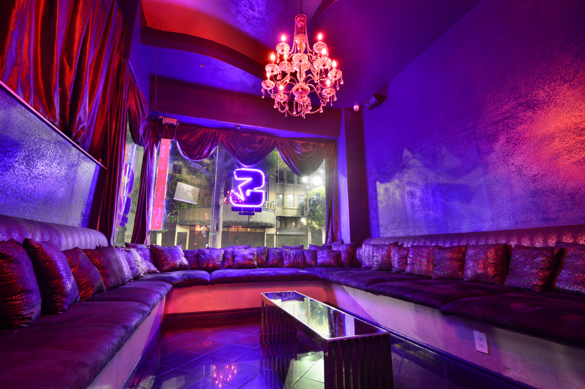 Purple lounge seating beside Star’s Hollywood Boulevard window
